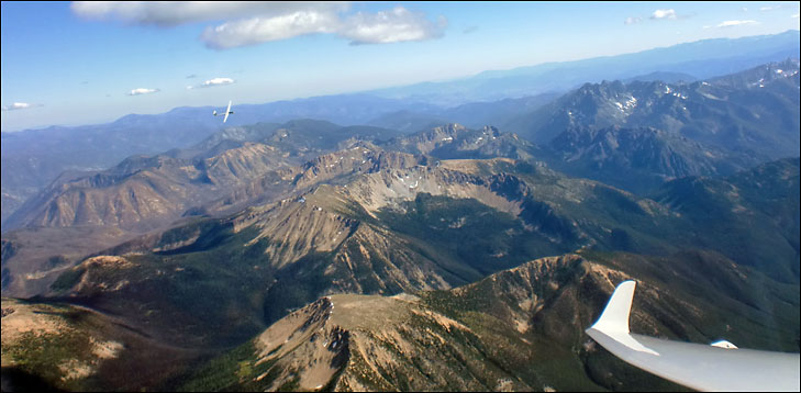 photo of sailplanes in flight over mountains