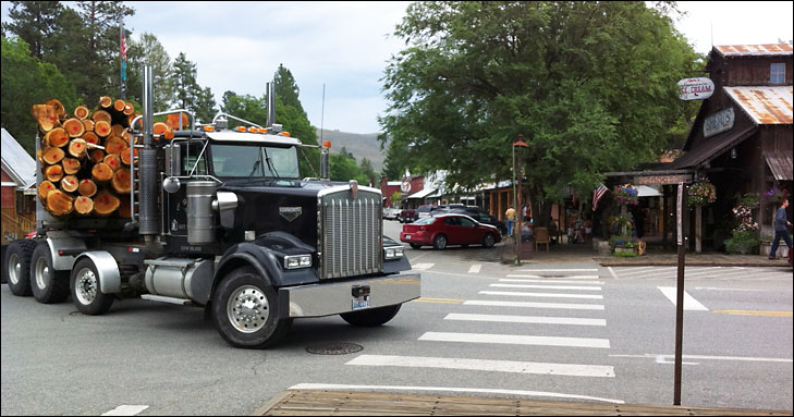 photo of loaded log truck in downtown winthrop